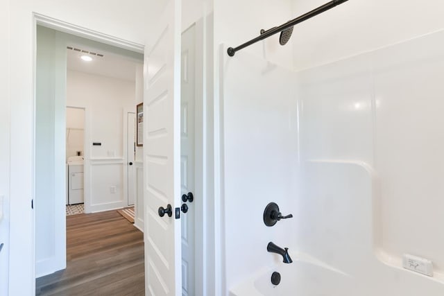 108 Hunters Way, Opelika, AL 36801 - bathroom featuring bathing tub / shower combination, washer / dryer, and wood finished floors