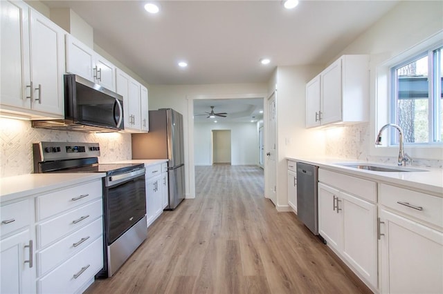 762 Lee Road 197, Phenix City, AL 36870 - kitchen featuring light wood-style flooring, recessed lighting, a sink, white cabinets, and appliances with stainless steel finishes