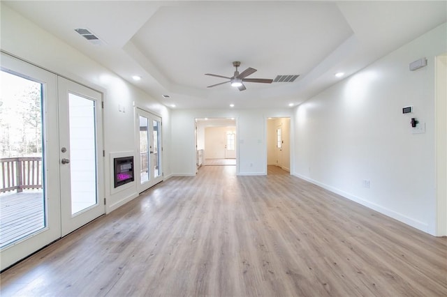 762 Lee Road 197, Phenix City, AL 36870 - unfurnished living room with visible vents, french doors, light wood-type flooring, and a raised ceiling