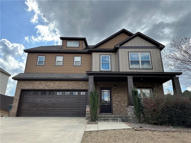 craftsman inspired home featuring a porch, board and batten siding, concrete driveway, an attached garage, and brick siding