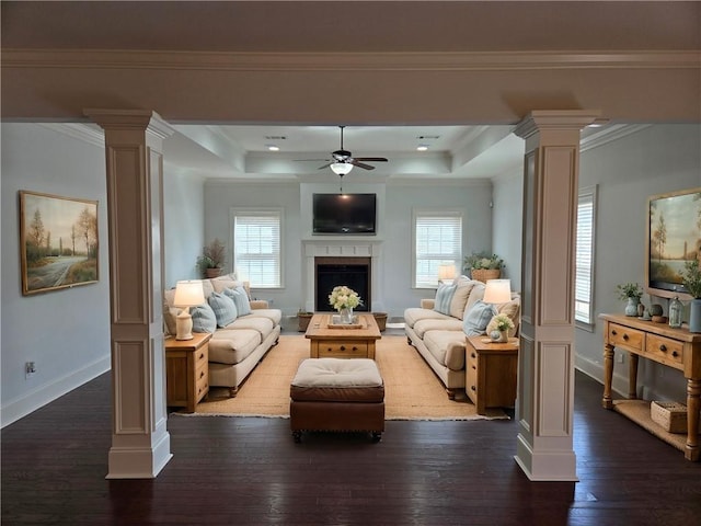 living area featuring decorative columns, a healthy amount of sunlight, and ceiling fan