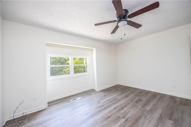 unfurnished room with ceiling fan and light hardwood / wood-style floors