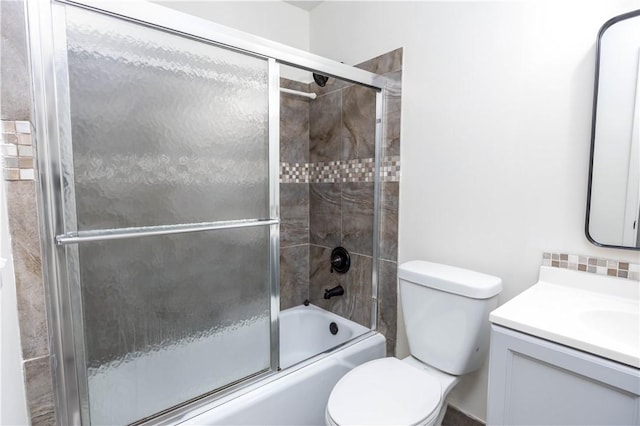 full bathroom with vanity, toilet, and bath / shower combo with glass door