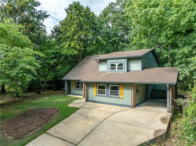 front of property featuring covered porch, a front lawn, and a carport