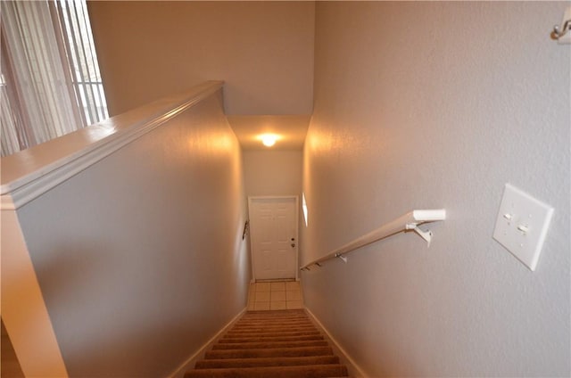 staircase featuring baseboards