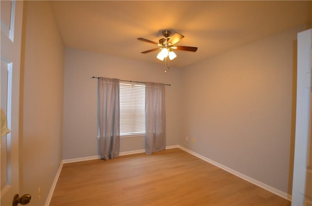 unfurnished room with baseboards, a ceiling fan, and light wood finished floors