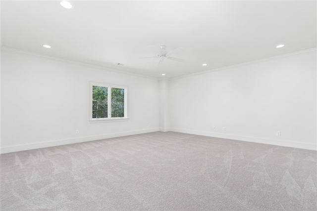 carpeted spare room with crown molding and ceiling fan