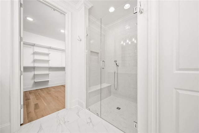 bathroom with a shower with door