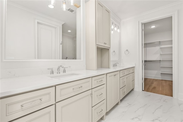 bathroom with vanity and ornamental molding