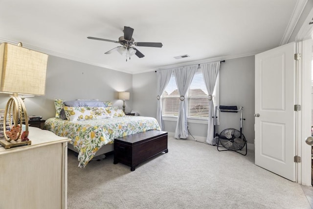 bedroom with ornamental molding, light colored carpet, and ceiling fan