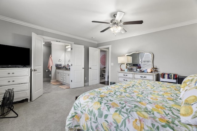 carpeted bedroom with ensuite bath, ornamental molding, and ceiling fan