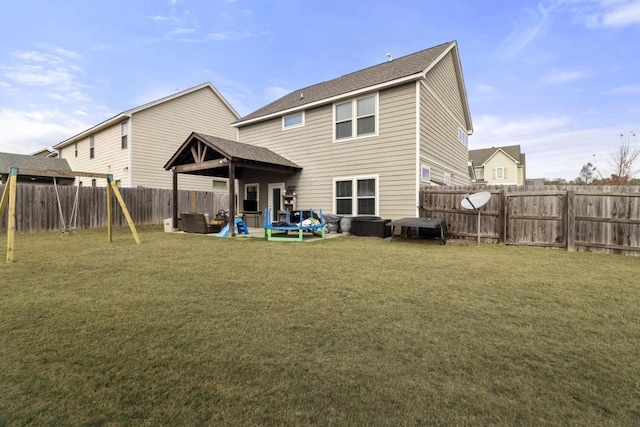 rear view of property with a patio and a lawn