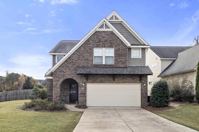 view of front of house featuring a garage and a front lawn