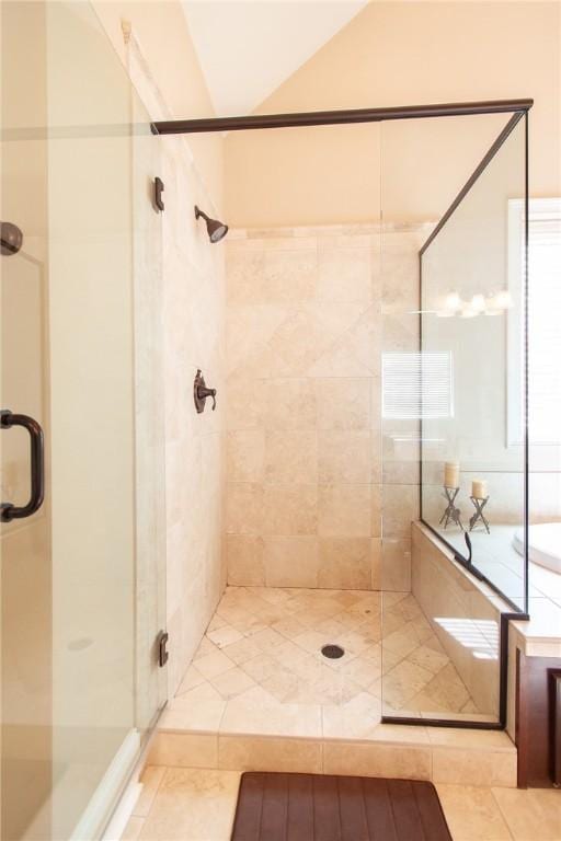 bathroom with tile patterned flooring and walk in shower