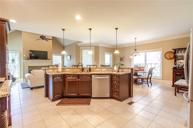 kitchen featuring hanging light fixtures, ceiling fan with notable chandelier, stainless steel dishwasher, and a center island with sink