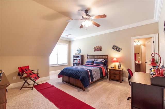 carpeted bedroom featuring ensuite bathroom, vaulted ceiling, ceiling fan, and ornamental molding