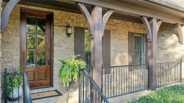 view of exterior entry with covered porch