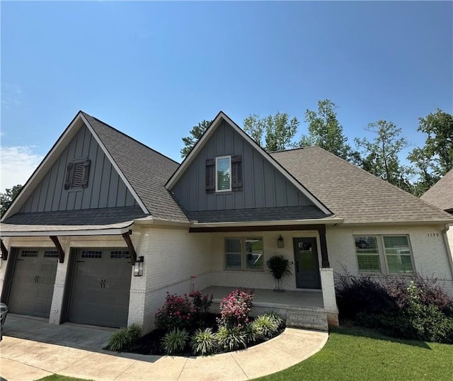 1179 Still Hunt Ln, Auburn, AL 36832 - view of front of property with board and batten siding, covered porch, brick siding, and a shingled roof