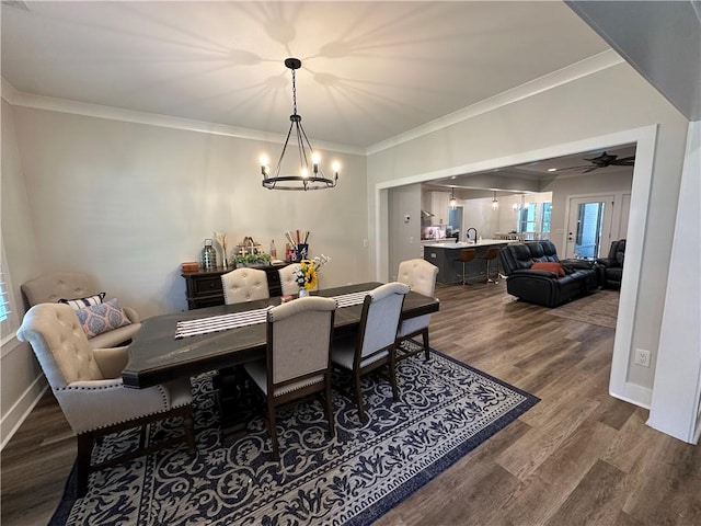 1179 Still Hunt Ln, Auburn, AL 36832 - dining space with a chandelier, crown molding, dark wood-style flooring, and a ceiling fan