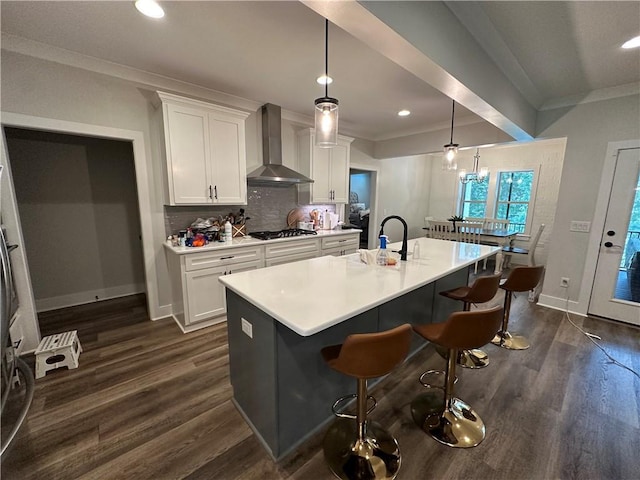 1179 Still Hunt Ln, Auburn, AL 36832 - kitchen featuring wall chimney range hood, white cabinetry, stainless steel gas stovetop, dark wood-style flooring, and crown molding