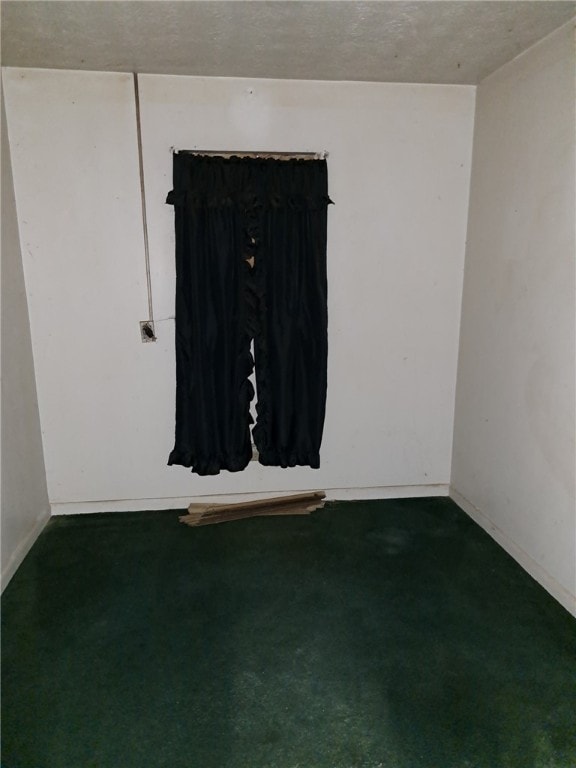 spare room with carpet flooring and baseboards