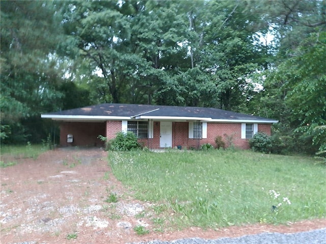 ranch-style home with a carport, driveway, and brick siding