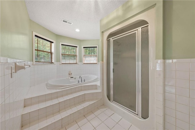 3519 Anderson Rd, Opelika, AL 36801 - full bath featuring tile walls, tile patterned floors, a garden tub, a stall shower, and a wainscoted wall