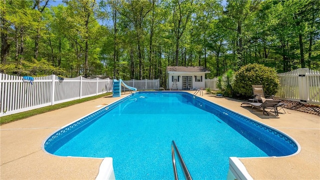 3519 Anderson Rd, Opelika, AL 36801 - view of pool with a water slide, a patio area, an outbuilding, a fenced backyard, and a storage structure