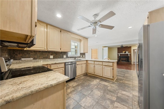 3519 Anderson Rd, Opelika, AL 36801 - kitchen featuring stainless steel appliances, light brown cabinetry, ceiling fan, a peninsula, and tasteful backsplash