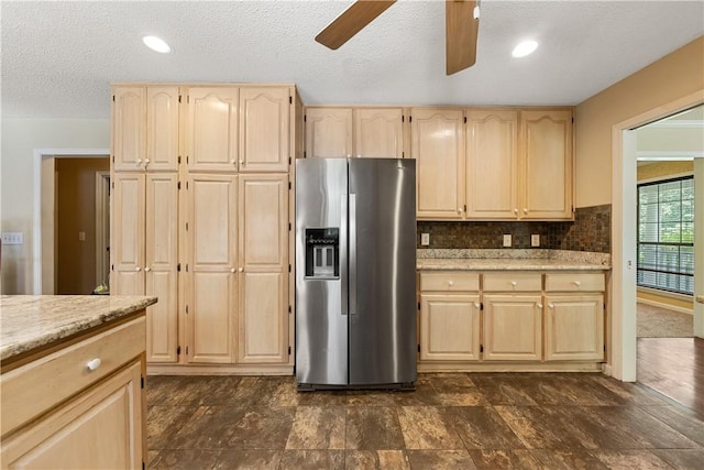 3519 Anderson Rd, Opelika, AL 36801 - kitchen with stainless steel refrigerator with ice dispenser, light brown cabinetry, ceiling fan, a textured ceiling, and light stone counters