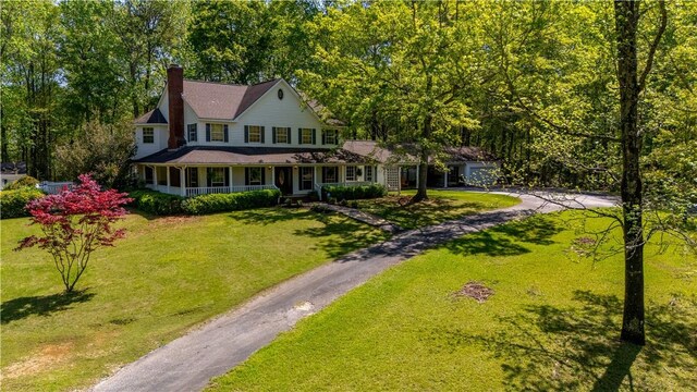 3519 Anderson Rd, Opelika, AL 36801 - view of front facade with asphalt driveway, a porch, a chimney, and a front lawn