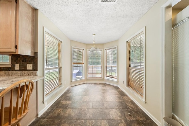 3519 Anderson Rd, Opelika, AL 36801 - unfurnished dining area featuring baseboards and a textured ceiling
