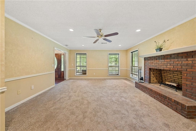 3519 Anderson Rd, Opelika, AL 36801 - unfurnished living room featuring carpet floors, ceiling fan, a textured ceiling, crown molding, and a brick fireplace