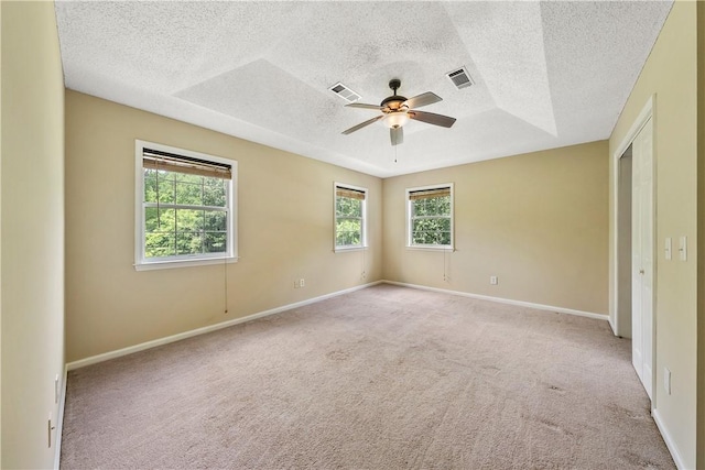 3519 Anderson Rd, Opelika, AL 36801 - empty room with light carpet, a textured ceiling, ceiling fan, and a raised ceiling