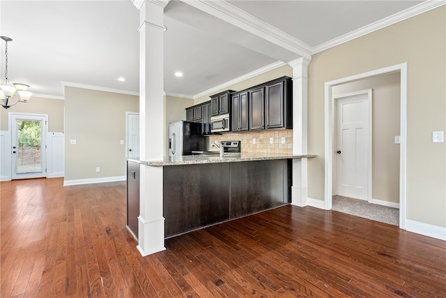 kitchen featuring light stone countertops, kitchen peninsula, crown molding, and stainless steel appliances