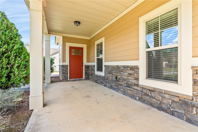 view of exterior entry with a porch