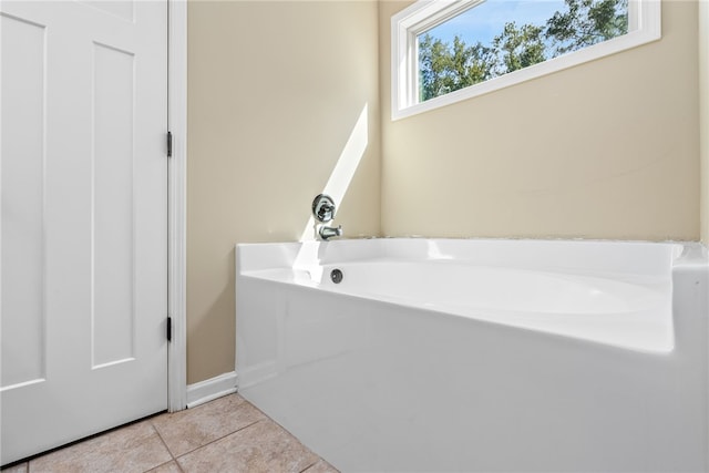 bathroom featuring tile patterned floors and a bath