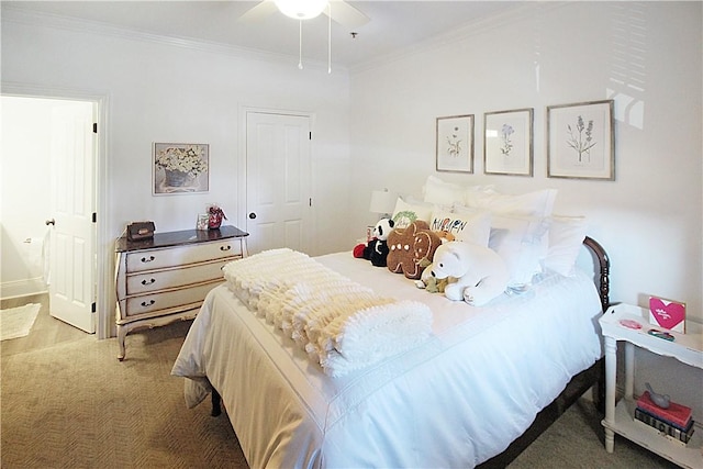 carpeted bedroom featuring ensuite bath, ceiling fan, and crown molding