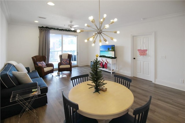 dining room with ceiling fan with notable chandelier, dark hardwood / wood-style flooring, and crown molding