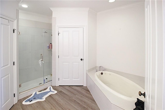 bathroom with separate shower and tub, crown molding, and hardwood / wood-style floors