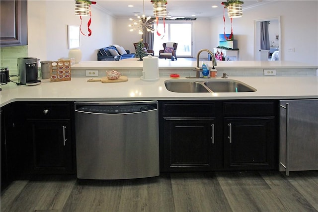 kitchen featuring dishwasher, sink, dark wood-type flooring, tasteful backsplash, and crown molding