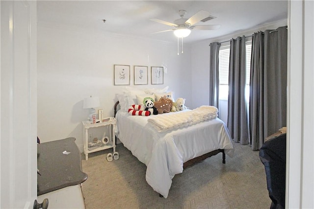 carpeted bedroom featuring ceiling fan and crown molding