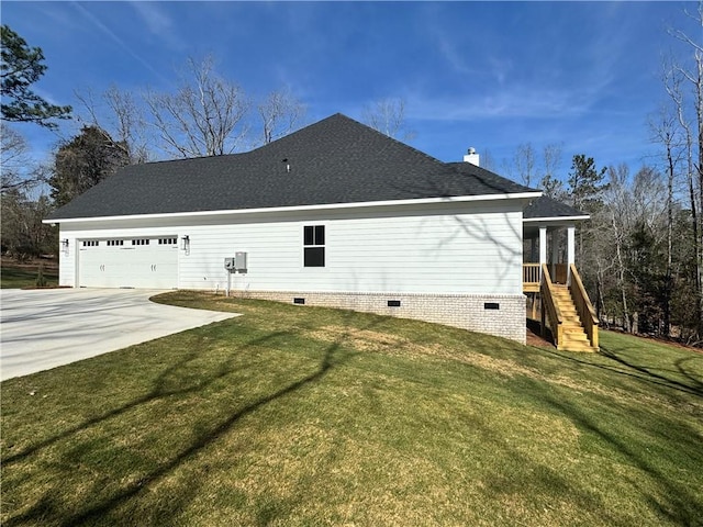 view of side of property featuring a garage and a lawn