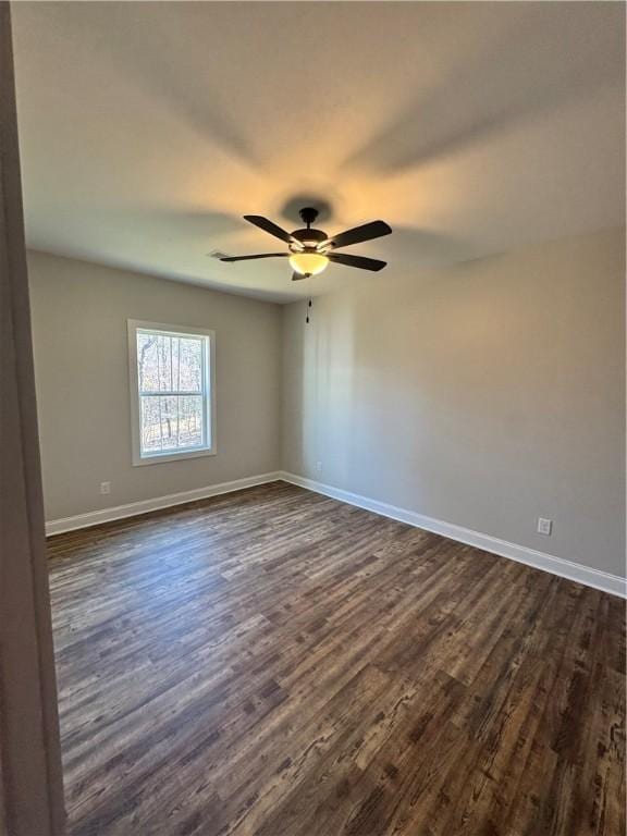 empty room featuring dark wood-type flooring and ceiling fan