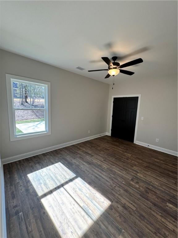 unfurnished bedroom with dark hardwood / wood-style floors and ceiling fan