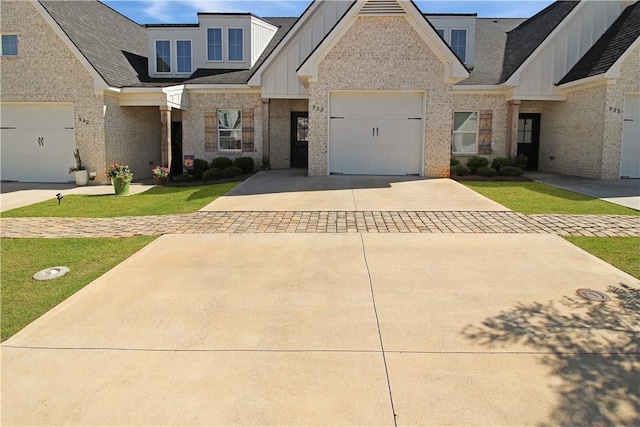 view of front of home with concrete driveway, brick siding, roof with shingles, and board and batten siding