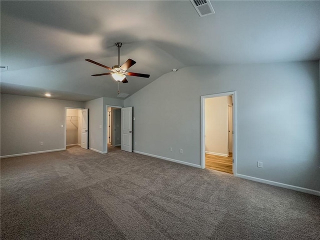 unfurnished bedroom featuring carpet floors, baseboards, and vaulted ceiling