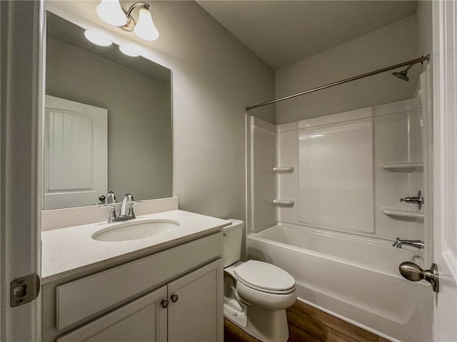 full bathroom featuring  shower combination, vanity, toilet, and wood finished floors