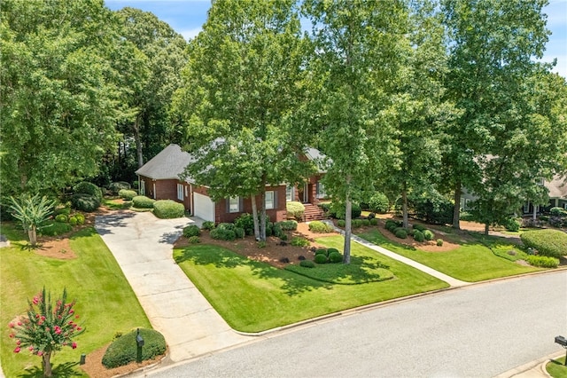 1421 Crossing Way, Auburn, AL 36830 - obstructed view of property with concrete driveway, a garage, a front yard, and brick siding