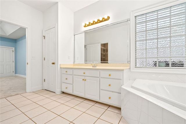 1421 Crossing Way, Auburn, AL 36830 - bathroom featuring vanity, a garden tub, tile patterned flooring, and a closet